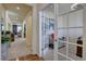 Bright hallway with hardwood and carpet flooring leading to a living area and study with french doors at 3164 S Kirk Way, Aurora, CO 80013