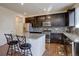 Modern kitchen with granite countertops, stainless steel appliances, and a center island with seating at 3164 S Kirk Way, Aurora, CO 80013