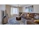 Inviting living room featuring a leather sofa, decorative rug and natural light at 3164 S Kirk Way, Aurora, CO 80013