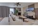 Open-concept living room with a decorative wall, fireplace, comfortable seating, and plenty of natural light at 3164 S Kirk Way, Aurora, CO 80013