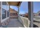 Inviting covered porch featuring stone accents and a view of the neighborhood street at 3164 S Kirk Way, Aurora, CO 80013