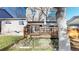 Backyard featuring a wood deck, green grass and some bushes, with a hot tub and a tree at 17588 E Dickenson Pl, Aurora, CO 80013