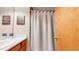 Bathroom featuring decor, oak cabinets, and a shower with a decorative shower curtain at 17588 E Dickenson Pl, Aurora, CO 80013