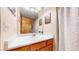 Bathroom with oak cabinets, decorative wall art, and ample countertop space at 17588 E Dickenson Pl, Aurora, CO 80013