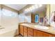 Bathroom with a double sink vanity, soaking tub, and stylish tile accents at 17588 E Dickenson Pl, Aurora, CO 80013