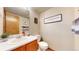 Cozy powder room with decorative wall art, wooden accents, and a single sink vanity at 17588 E Dickenson Pl, Aurora, CO 80013