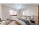 Bright bedroom featuring a ceiling fan, comfy seating, neutral decor, and a cozy bed at 17588 E Dickenson Pl, Aurora, CO 80013