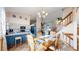 Bright dining area adjacent to the kitchen, featuring a stylish chandelier and staircase access at 17588 E Dickenson Pl, Aurora, CO 80013