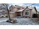 Beautiful two-story home with a covered porch, a well-maintained yard, and charming winter details at 17588 E Dickenson Pl, Aurora, CO 80013