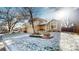A two-story home boasting a well-manicured front yard, covered porch, and two-car garage, captured in winter at 17588 E Dickenson Pl, Aurora, CO 80013