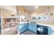 Well-lit kitchen featuring blue cabinetry, a white countertop, and stainless steel appliances at 17588 E Dickenson Pl, Aurora, CO 80013