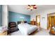 Comfortable main bedroom with large bed, seating area, and view into the bathroom at 17588 E Dickenson Pl, Aurora, CO 80013