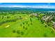 Expansive aerial view of lush green golf course with mature trees and mountain views in the background at 4626 E Links Dr, Centennial, CO 80122