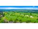 Picturesque aerial view of a well-maintained golf course with ponds and surrounding greenery at 4626 E Links Dr, Centennial, CO 80122