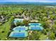 Aerial shot of tennis courts, pool, clubhouse, and neighborhood at 4626 E Links Dr, Centennial, CO 80122