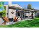 Inviting backyard with a stone patio, pergola, seating area, and lush lawn perfect for outdoor entertaining at 4626 E Links Dr, Centennial, CO 80122