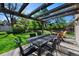 Backyard patio featuring an outdoor dining table and chairs beneath a wooden pergola with string lights at 4626 E Links Dr, Centennial, CO 80122