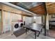 Laundry room with modern appliances, sink and folding table, next to a ping pong table at 4626 E Links Dr, Centennial, CO 80122