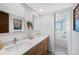 This bathroom features double sinks, modern fixtures, and a view into the shower and bath space at 4626 E Links Dr, Centennial, CO 80122