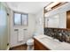 Modern bathroom featuring a glass shower, decorative mirror, and stylish sink at 4626 E Links Dr, Centennial, CO 80122