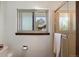 This well-lit bathroom offers a glass-enclosed shower and a window overlooking the exterior of the home at 4626 E Links Dr, Centennial, CO 80122