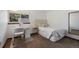 Bright bedroom featuring a single bed, desk, and carpeted floors, creating a cozy and functional space at 4626 E Links Dr, Centennial, CO 80122