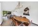 Dining room with natural light from large windows and a modern chandelier and wood table at 4626 E Links Dr, Centennial, CO 80122