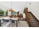 Open-concept dining room with tile floors, modern chandelier, and a staircase at 4626 E Links Dr, Centennial, CO 80122