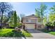 Two-story home with a two-car garage, neutral siding, brick accents, and well-maintained landscaping at 4626 E Links Dr, Centennial, CO 80122