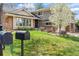 Charming two-story home featuring a well-manicured front yard and a mix of brick and siding exterior, with a blooming tree at 4626 E Links Dr, Centennial, CO 80122