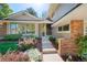 Inviting front entrance with stone steps, colorful landscaping, and a glimpse of the home's architectural details at 4626 E Links Dr, Centennial, CO 80122