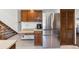 Kitchen area with stainless steel refrigerator, cabinets and desk at 4626 E Links Dr, Centennial, CO 80122