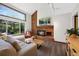 Cozy living room with brick fireplace, large window, and comfortable seating at 4626 E Links Dr, Centennial, CO 80122