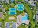 Overhead view featuring well-maintained tennis courts, swimming pool and surrounding neighborhood at 4626 E Links Dr, Centennial, CO 80122