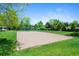 Sandy community volleyball court surrounded by lush green grass provides a fun recreational area at 4626 E Links Dr, Centennial, CO 80122