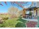 Landscaped backyard featuring a covered patio with a hot tub and scenic views at 10259 Fairgate Way, Highlands Ranch, CO 80126