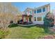 Backyard featuring a deck, patio, well-manicured lawn, and mature landscaping at 10259 Fairgate Way, Highlands Ranch, CO 80126
