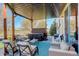 Inviting backyard patio featuring a hot tub, comfortable seating, and outdoor lighting at 10259 Fairgate Way, Highlands Ranch, CO 80126