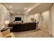Basement media room with leather seating, TV, and adjacent workout area at 10259 Fairgate Way, Highlands Ranch, CO 80126