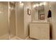 Bathroom with a glass-door shower and a vanity with bright lighting at 10259 Fairgate Way, Highlands Ranch, CO 80126