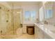 Bathroom featuring glass enclosed shower, shutters, and makeup vanity at 10259 Fairgate Way, Highlands Ranch, CO 80126
