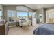 Bedroom with cozy sitting area, balcony access, and large windows with great outdoor views at 10259 Fairgate Way, Highlands Ranch, CO 80126