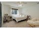 Cozy bedroom features a ceiling fan, a window and unique decor at 10259 Fairgate Way, Highlands Ranch, CO 80126