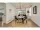 Cozy dining room with natural light, hardwood floors and stylish chairs and decor at 10259 Fairgate Way, Highlands Ranch, CO 80126
