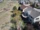 Two-story home boasts an outdoor patio, deck, and a large backyard with mature trees and lush green grass at 10259 Fairgate Way, Highlands Ranch, CO 80126