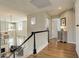 Upstairs hallway with hardwood floors, view of great room, and access to other rooms at 10259 Fairgate Way, Highlands Ranch, CO 80126