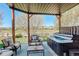 Backyard hot tub area with stylish patio furniture and picturesque views at 10259 Fairgate Way, Highlands Ranch, CO 80126