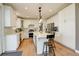 Modern kitchen with white cabinetry, stainless steel appliances, and a spacious island at 10259 Fairgate Way, Highlands Ranch, CO 80126