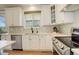 Bright kitchen with ample counter space, modern appliances, and sleek white cabinets at 10259 Fairgate Way, Highlands Ranch, CO 80126
