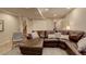 Spacious living room featuring a plush sectional sofa, soft lighting, and a staircase at 10259 Fairgate Way, Highlands Ranch, CO 80126